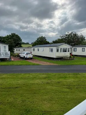 a car parked in front of a row of mobile homes at St Nicolas in Girvan