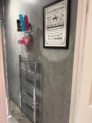 a picture hanging on a wall in a bathroom at 2 bedroom cottage in Ayr