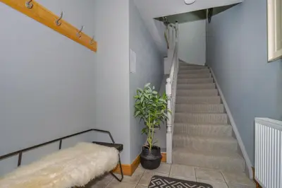 a staircase with a bench and a plant in a room at Hill View at Kenmuir in Dalbeattie