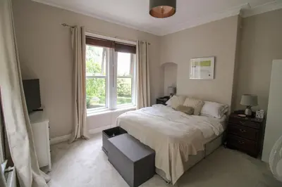 a bedroom with a bed and a window at Chertsey Mount Townhouse, within 10 minutes walk of Carlisle city centre, shops, pubs & restaurants in Carlisle