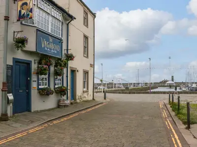 a building with a sign on it on a street at Duncan Square in Whitehaven
