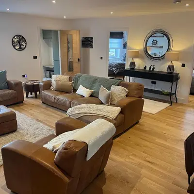 a living room with a couch and a piano at The Fishermans Rest in Castle Douglas
