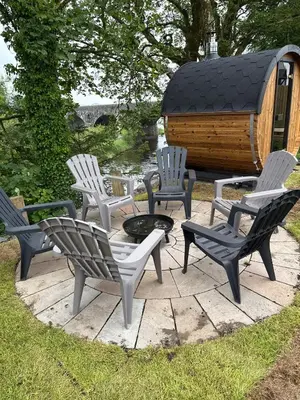 a group of chairs and a fire pit on a patio at The Fishermans Rest in Castle Douglas