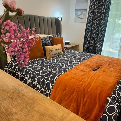 a bedroom with a bed with a vase of flowers at The Fishermans Rest in Castle Douglas