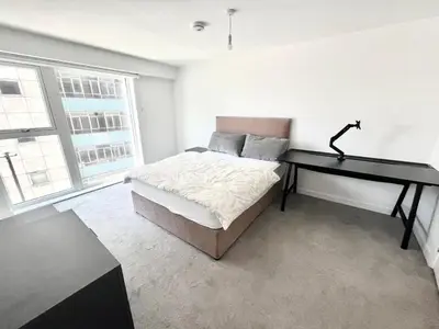 a bedroom with a desk and a bed in a room at Blucher St in Moffat
