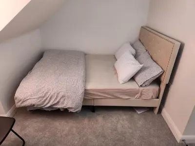a small bed with two pillows on it in a room at Edinburgh Road Nuneaton in Moffat