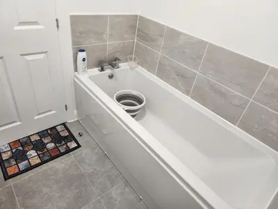 a bathroom with a toilet in a bath tub at Edinburgh Road Nuneaton in Moffat