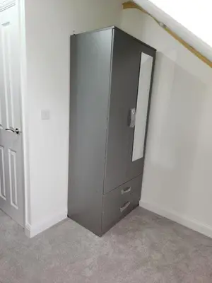 a gray cabinet in a room with a mirror at Edinburgh Road Nuneaton in Moffat