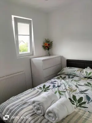 a bedroom with a bed with towels on it at Quiet 5BR Ideal for Groups in Moffat