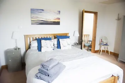 a bedroom with a bed with towels on it at Shoreside in Powfoot