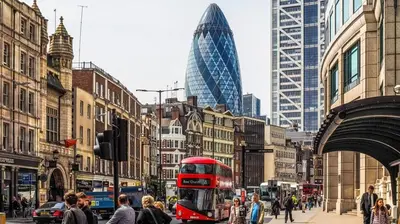 a red double decker bus on a busy city street at Smart Artistic studio in shoreditch in Moffat