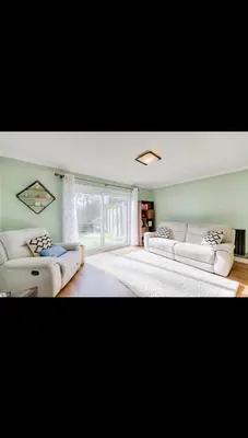 a living room with two white couches and a window at Modern home Close to all Cardiff venues in Moffat