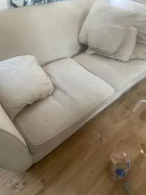 a white couch sitting on top of a wooden floor at Gravesend one room apartment in Moffat