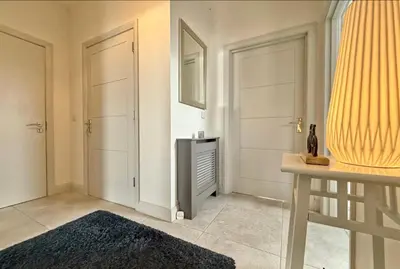 a living room with two doors and a rug at Stylish apartment in Portstewart in Moffat