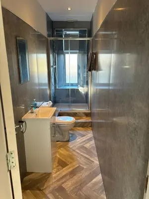 a bathroom with a toilet and a sink at 2 bedroom first floor flat- Bonnie Stays in Troon