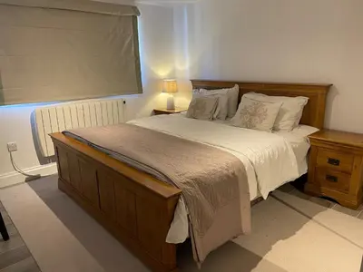a bedroom with a large bed and a window at Detached Annexe in Moffat