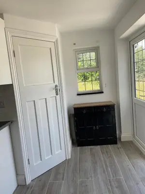 an empty room with a white door and a window at Detached Annexe in Moffat