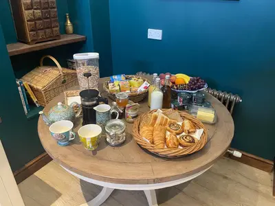 a table with baskets of food and bread on it at Craigielands House in Beattock