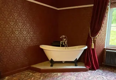 a bathroom with a white tub in a room at Craigielands House in Beattock