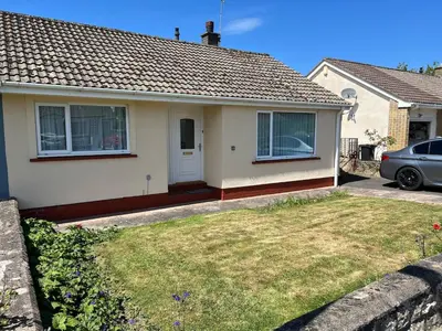a house with a car parked in front of it at 2 bedroom Lake district cottage in Cockermouth