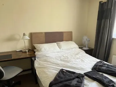 a bed in a room with a desk and a bed sidx sidx sidx at 2 bedroom Lake district cottage in Cockermouth
