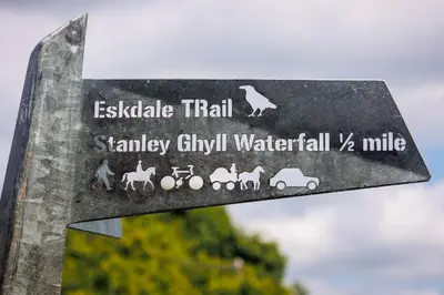 a sign on a pole with animals on it at The Old School House - Eskdale in Holmrook