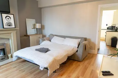 a living room with a bed and a couch at Saint Nico in Carlisle