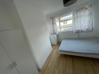 a small bedroom with a bed and a window at Large room with bathroom in Moffat