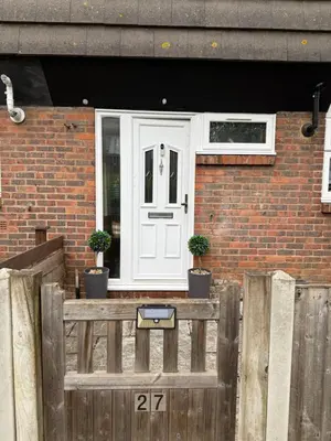 a house with a white door and a wooden fence at Traveler Nest in Moffat