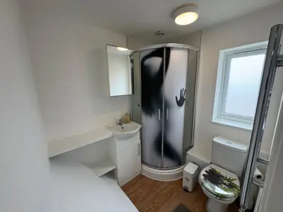 a small bathroom with a shower and a toilet at One bedroom studio in Moffat