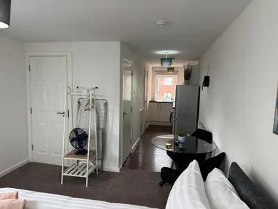 a living room with a couch and a table at One bedroom studio in Moffat