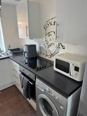 a kitchen with a microwave oven and a stove at One bedroom studio in Moffat