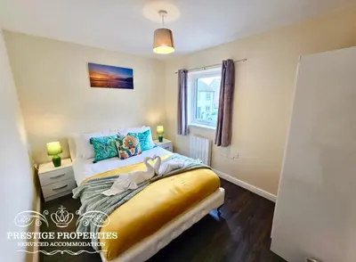 a small bedroom with a bed with a window at 12 Seacote Garden by Prestige Properties SA in St Bees