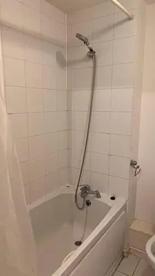 a bathroom with a bath tub with a shower at comfy residence in Moffat