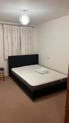 a bedroom with a bed in front of a window at comfy residence in Moffat