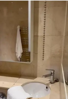 a bathroom with a sink and a mirror at 2Bedrooms flat in knightstbridge in Moffat