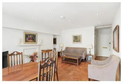 a living room with a table and a couch at 2 Bedroom Apartment Queensway in Moffat