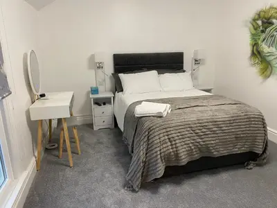 a bedroom with a bed and a nightstand and a bed and a table at Serenity Suites in Douglas