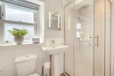 a bathroom with a toilet and a sink and a shower at 2 Bed in Dalston oc-g32205 in Dalston