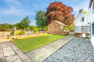a garden with a stone building and a fence at 2 Bed in Dalston oc-g32205 in Dalston
