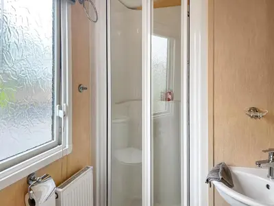 a bathroom with a shower and a sink at Keswick Reach in Cockermouth