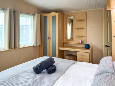 a bedroom with a bed with two pillows on it at Keswick Reach in Cockermouth