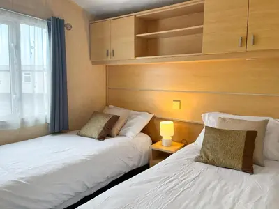 two beds sitting next to each other in a room at Keswick Reach in Cockermouth
