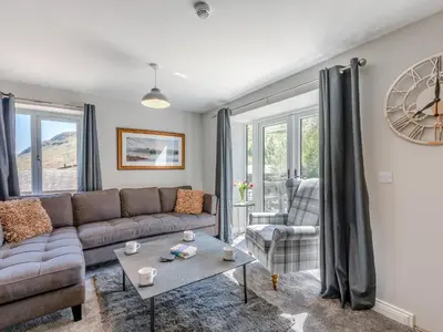 a living room with a couch and a table at Tower Cottage in Glenridding