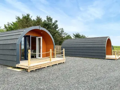 a small dome shaped building with a wooden porch at Douglas - Uk49286 in Stranraer