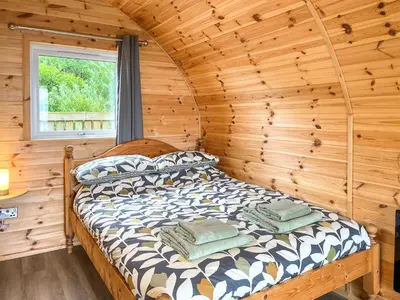 a bedroom with a bed in a log cabin at Douglas - Uk49286 in Stranraer