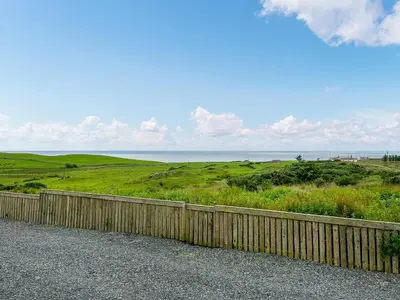 a fence on the side of a road near the ocean at Douglas - Uk49286 in Stranraer