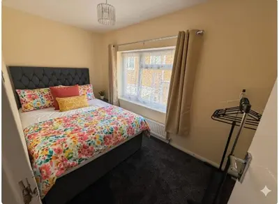 a bedroom with a bed and a window at Nayla house in Moffat