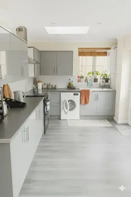 a kitchen with white cabinets and a washer and dryer at Nayla house in Moffat