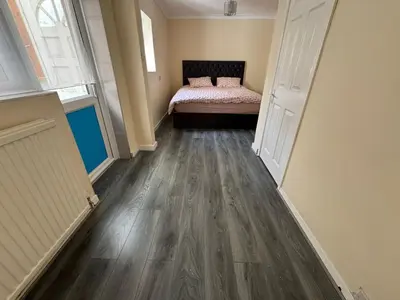 a bedroom with a bed and a wooden floor at Nayla house in Moffat